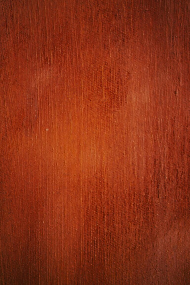 Close-up view of a rich brown textured wooden surface highlighting grain detail.